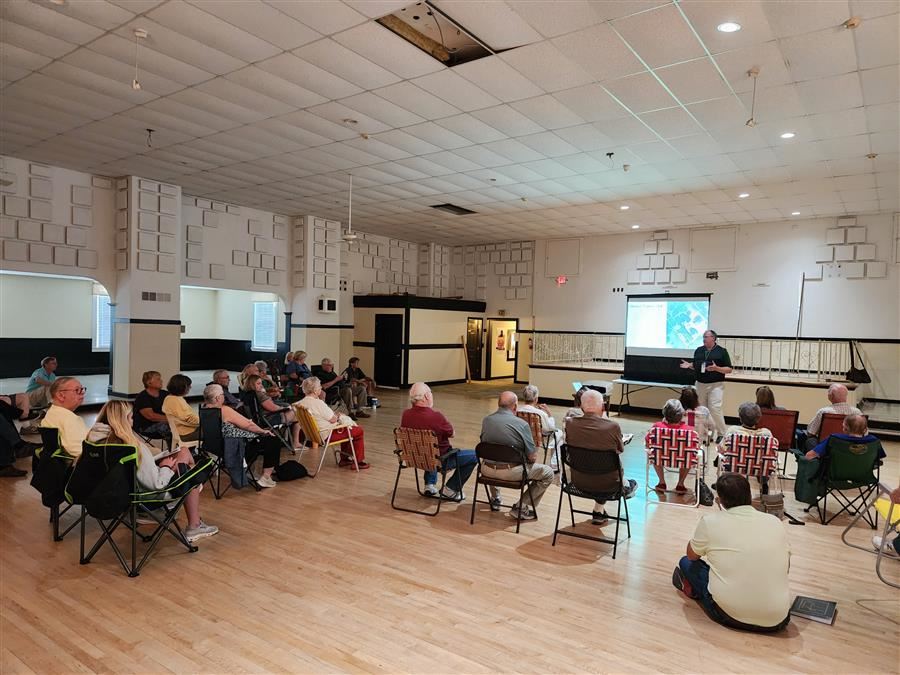  Area residents sit and listen to a presentation at the Concord Farmers Club building